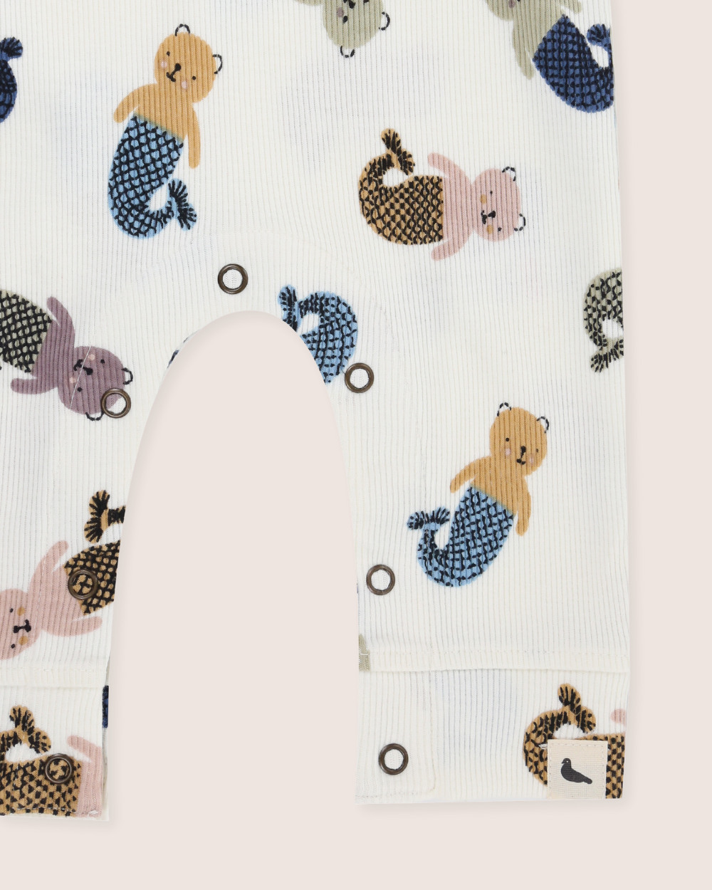 Baby sleepsuit with mermaid-themed animal print on a white background