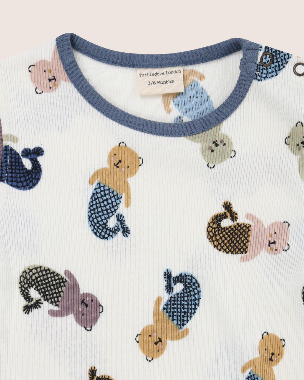 Baby outfit with mermaid-themed design on a white background