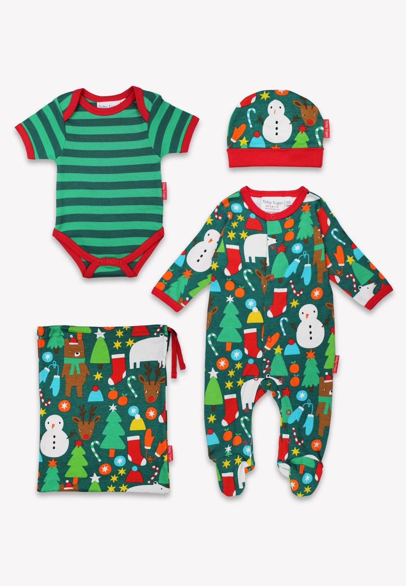 Set of Christmas-themed baby clothing including onesie, hat, and bag on a white background