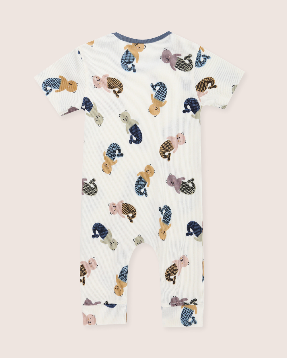 Children's sleepsuit with animal pattern on a light pink background
