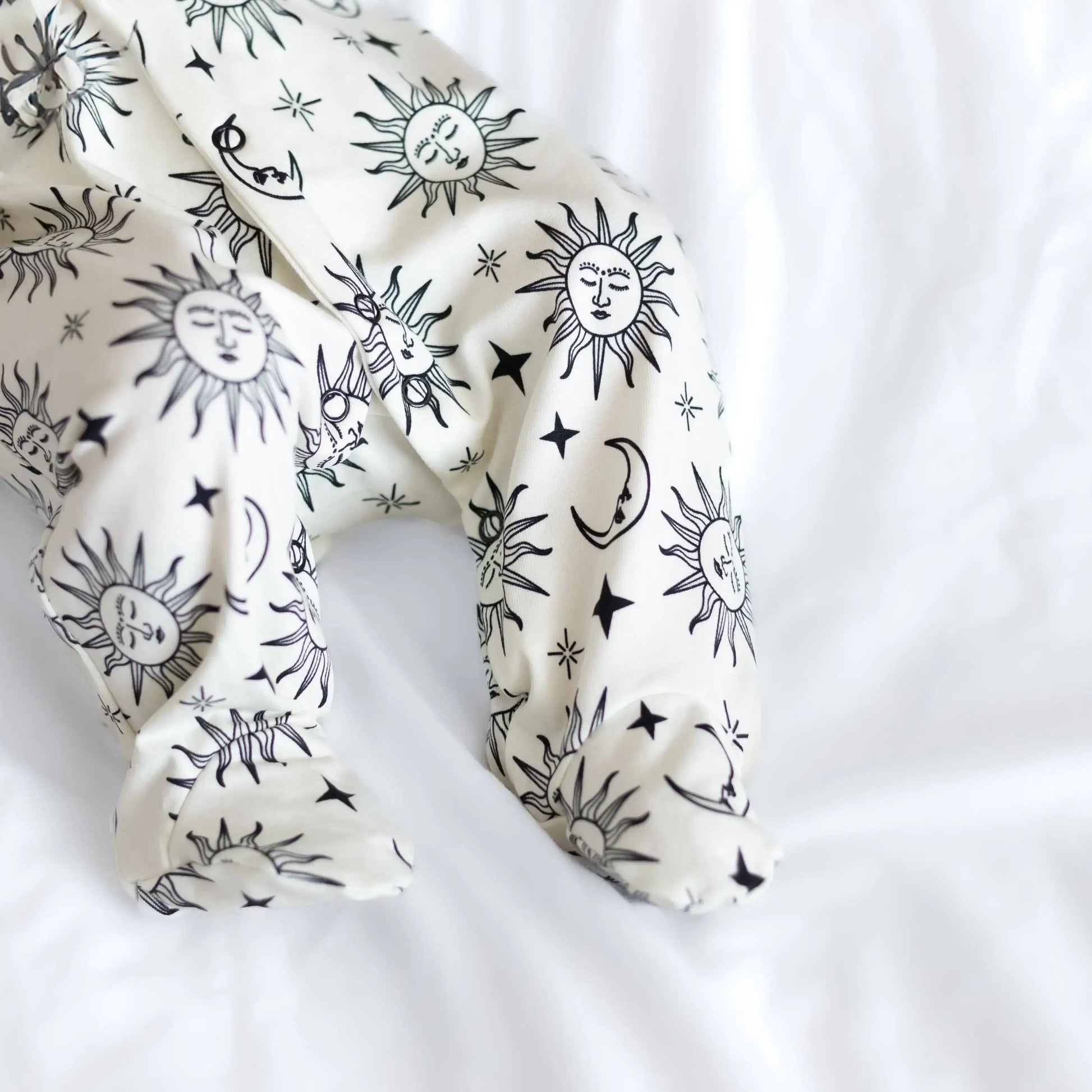 White with black sun and moon patterns on a white background