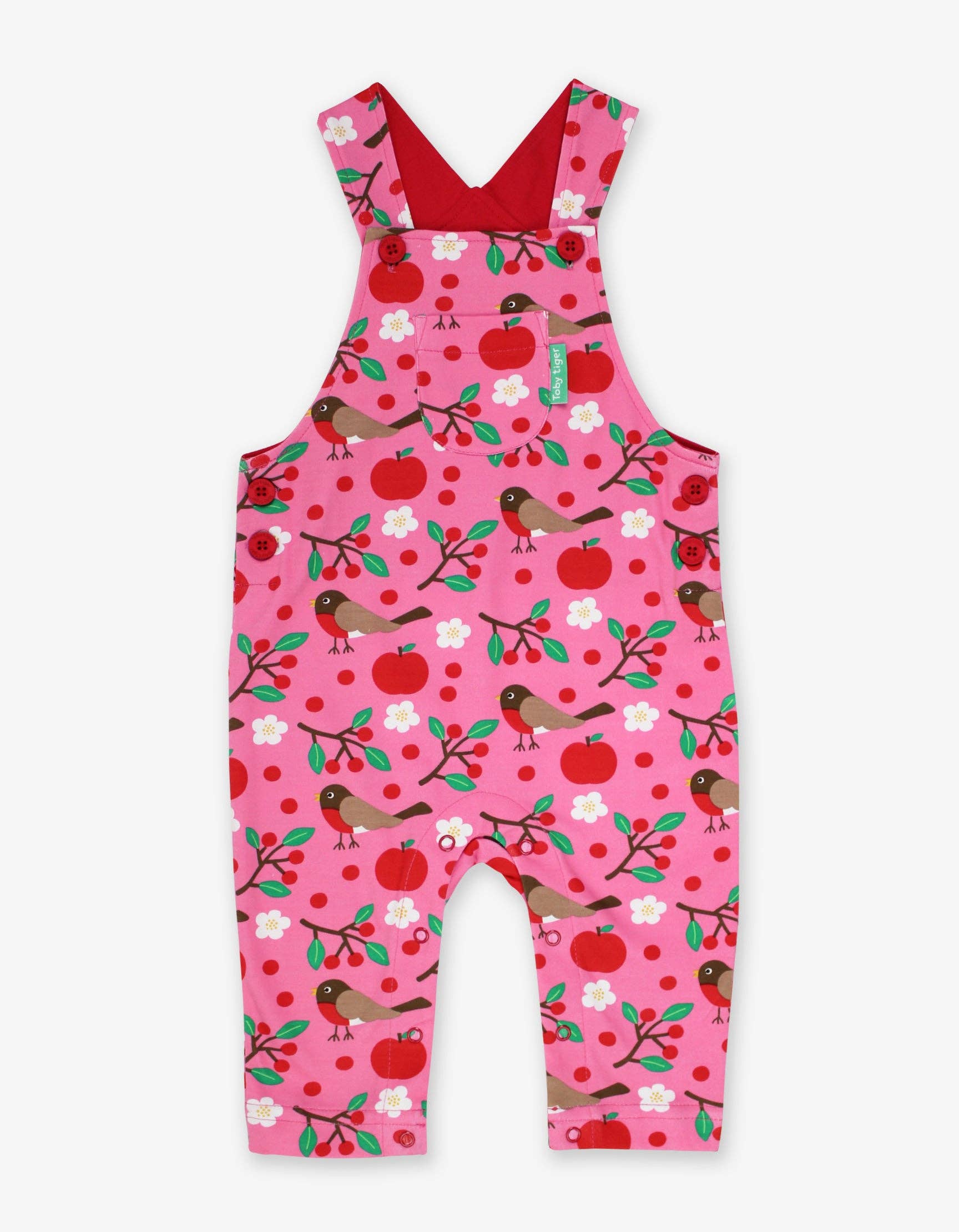 Pink children's overalls with bird and apple pattern on a white background
