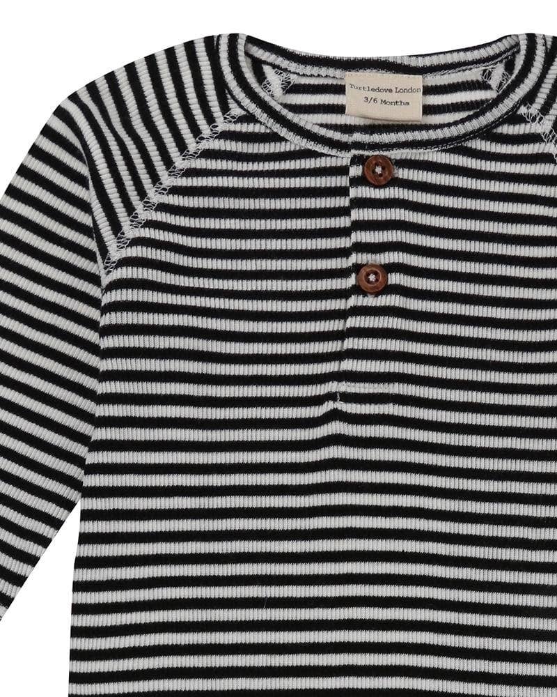 Black and white striped baby playsuit with buttons on a white background