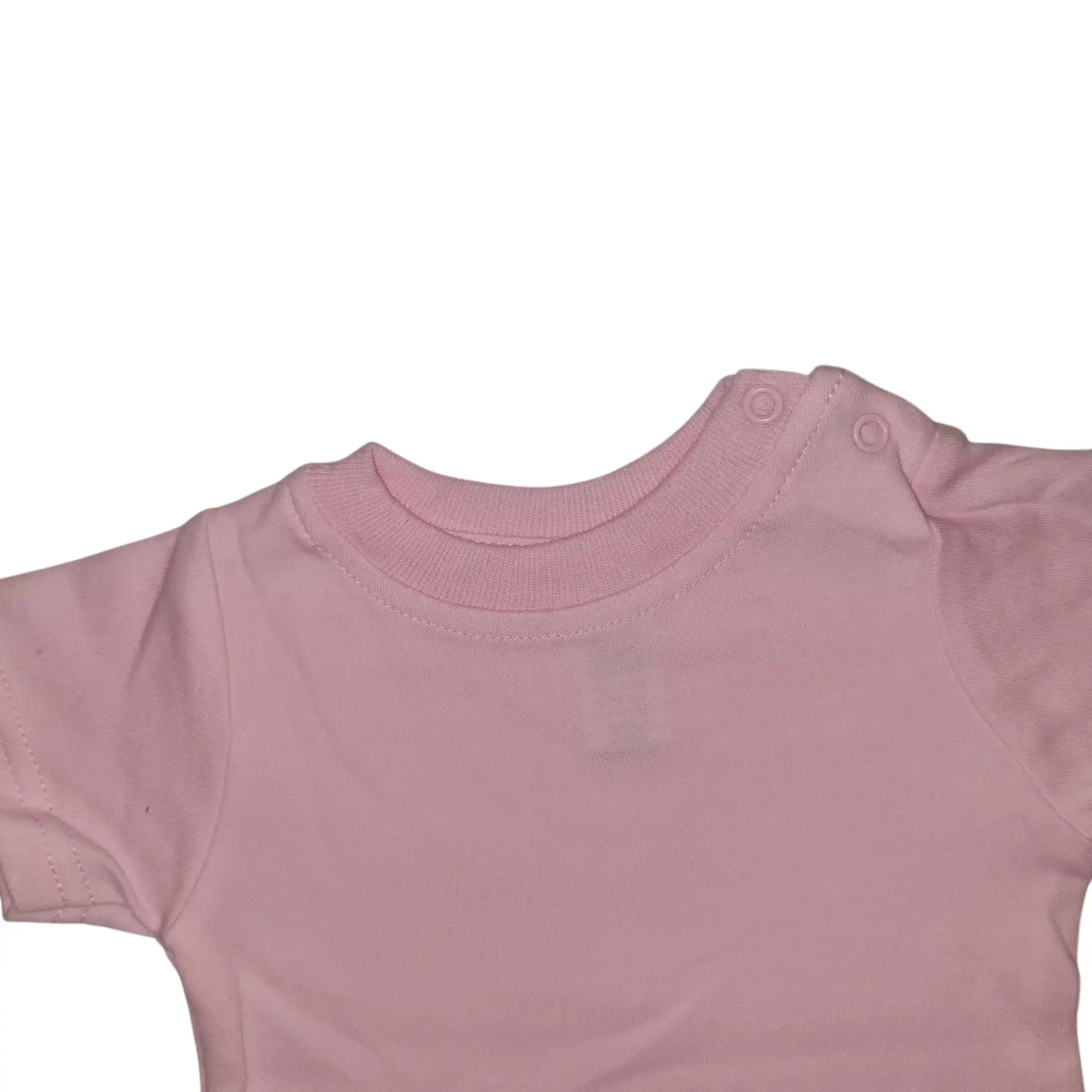 Closer look at the front of a pink cotton baby t-shirt with short sleeves and snap-on buttons at the shoulder, on a white background