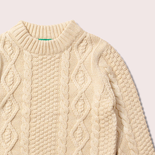 Beige cable knit sweater on a light gray background