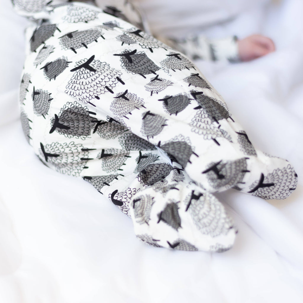 Close look up of baby sleepsuit back with sheep pattern