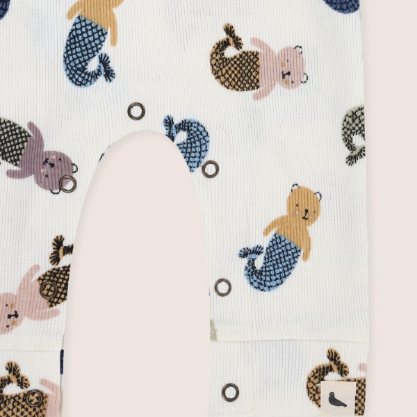 Baby sleepsuit with mermaid-themed animal print on a white background