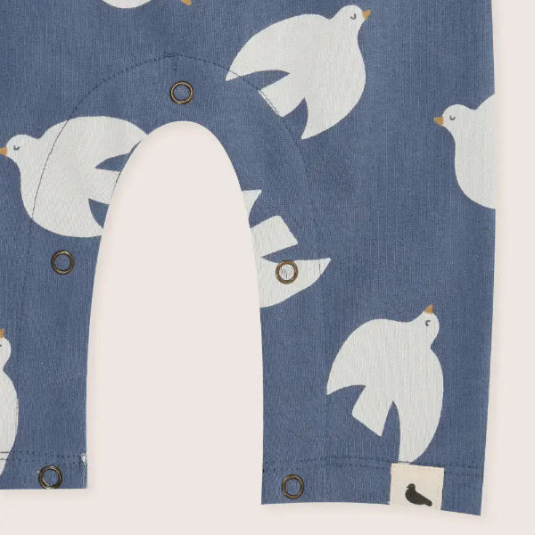 Children's shirt with white bird pattern on a blue background