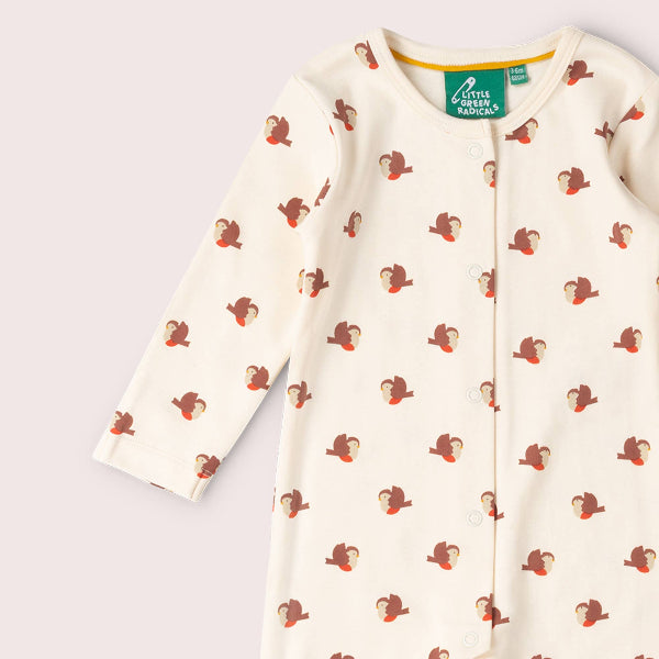 Baby onesie with monkey pattern on a light gray background