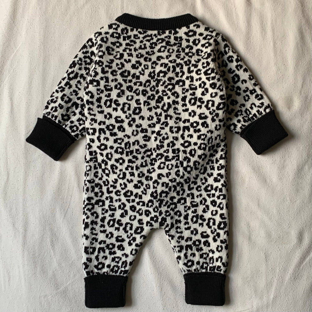 Leopard print baby romper on a white background