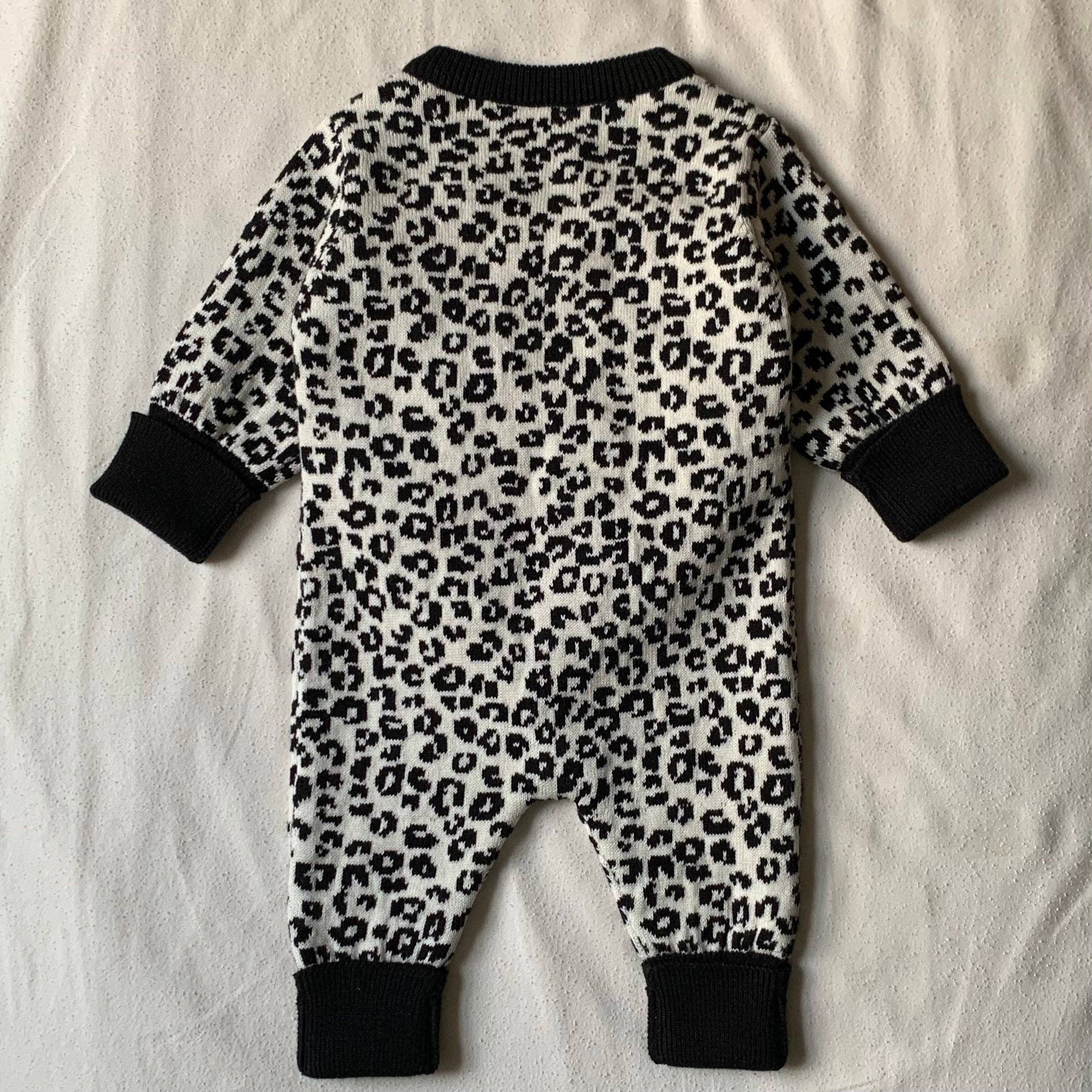 Leopard print baby romper on a white background