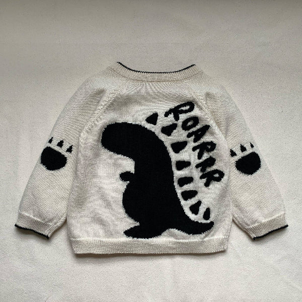 White sweater with black bear design and 'ROAR' text on a light gray background
