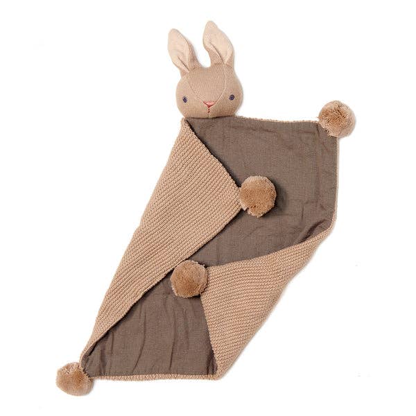 Knitted blanket with a plush rabbit toy on a white background