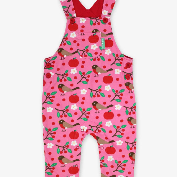 Pink children's overalls with bird and apple pattern on a white background