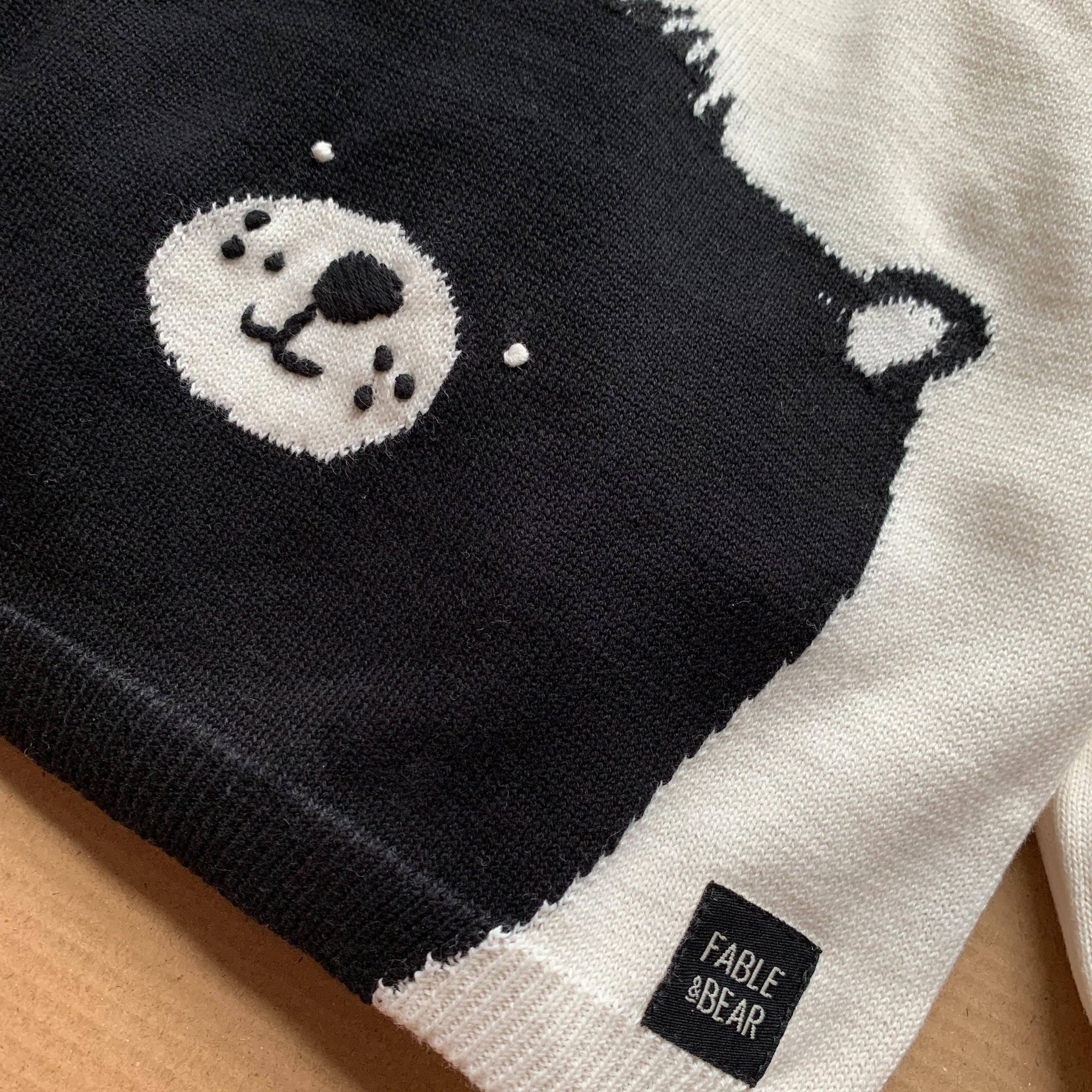 Black and white bear-themed product with 'Fable & Bear' label on a wooden surface
