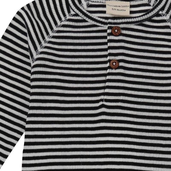 Black and white striped baby playsuit with buttons on a white background