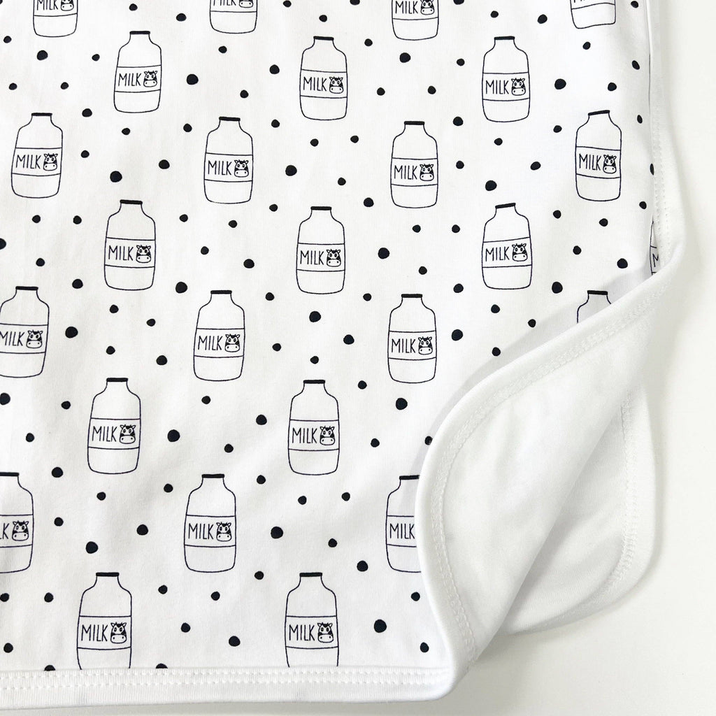 White fabric with black milk bottle pattern on a white background