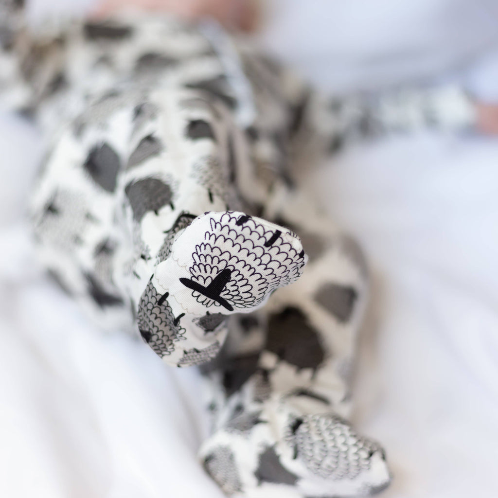 Baby's feet with sheep design on a white background