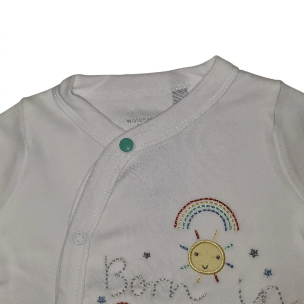 Close-up front detail of a white cotton baby grow with snap button fastening on a white background