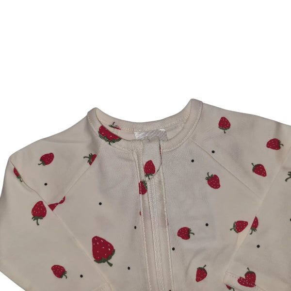 White cotton babygrow with red strawberry print on a white background