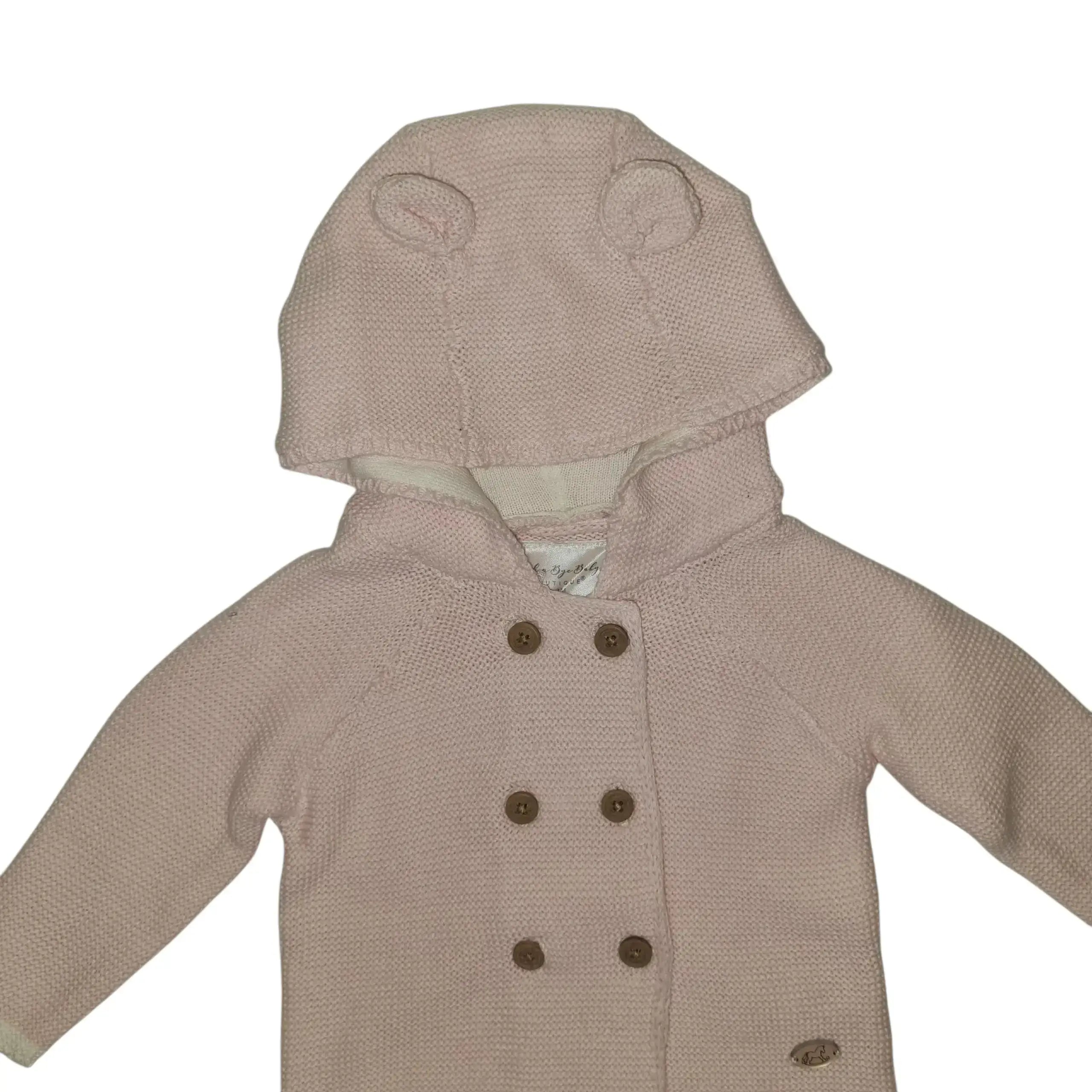 Closer look of a pink cotton baby cardigan with hood and little ears, featuring front button detail, on a white background