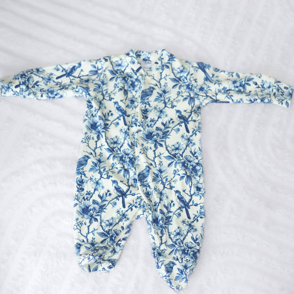 Baby onesie with blue floral pattern on a white background