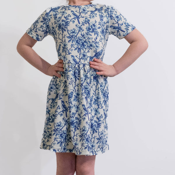 Woman wearing a blue floral dress on a white background