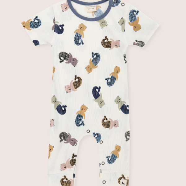 Baby sleepsuit with mermaid and sea-themed print on a light pink background
