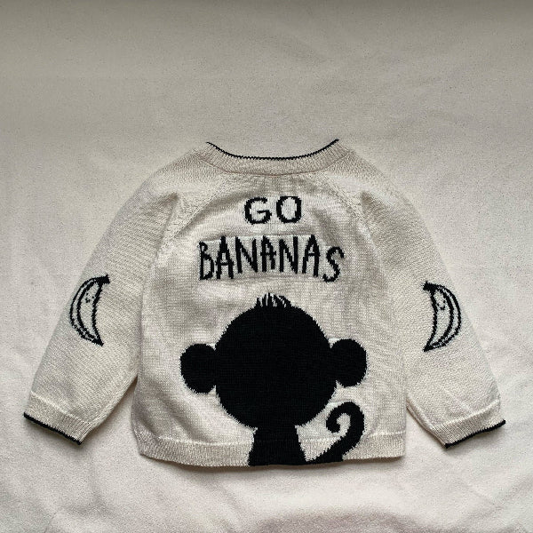 White jumper/sweater with black monkey design and 'GO BANANAS' text on a light gray background