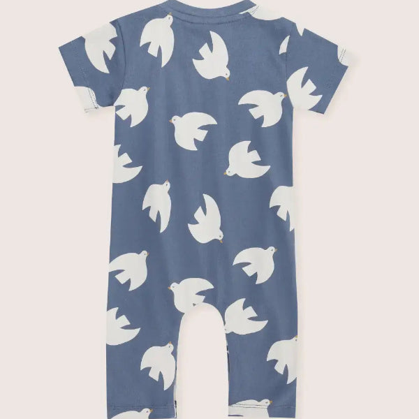 Blue romper with white bird pattern on a light gray background