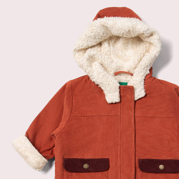 Red jacket with white fur lining on a light gray background