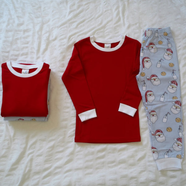 Red long-sleeve shirt and patterned pants on a white textured surface